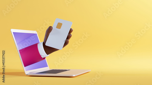 3d illustration. African cartoon character hand sticking out the laptop screen, holding plastic card with chip. Internet business clip art isolated on yellow background. Online service application photo