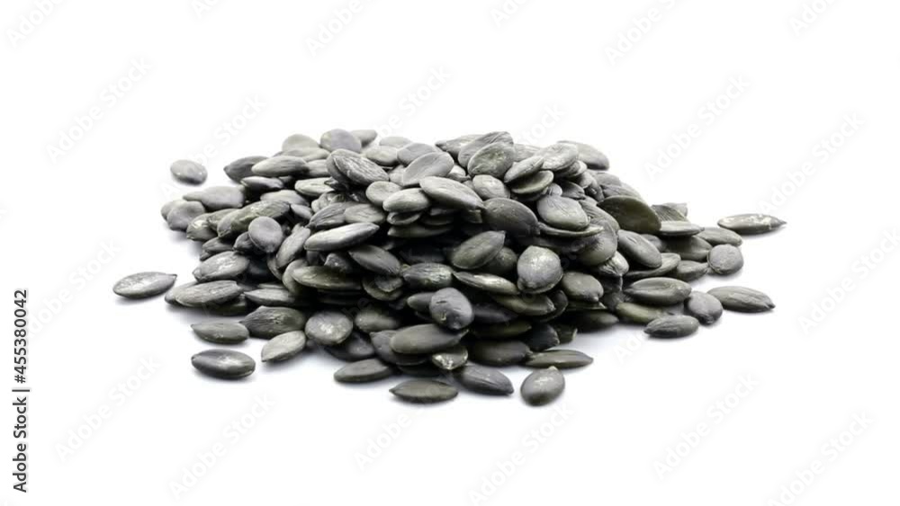 Heap of pumpkin seeds rotating over white background, healthy dieting or food concept Heap of pumpkin seeds rotating over white background, healthy dieting or food concept