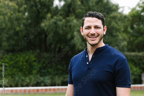 portrait of young Hispanic man student at the park in latin america