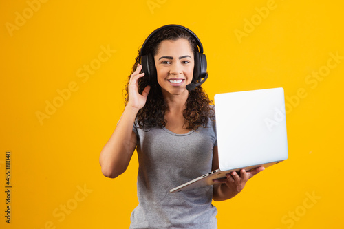 Fényképezés young receptionist woman working with notebook and headset.