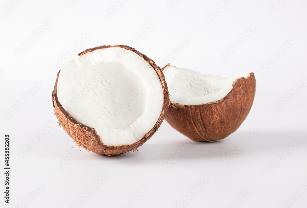 Two halves of fresh coconut on white background. Close-up