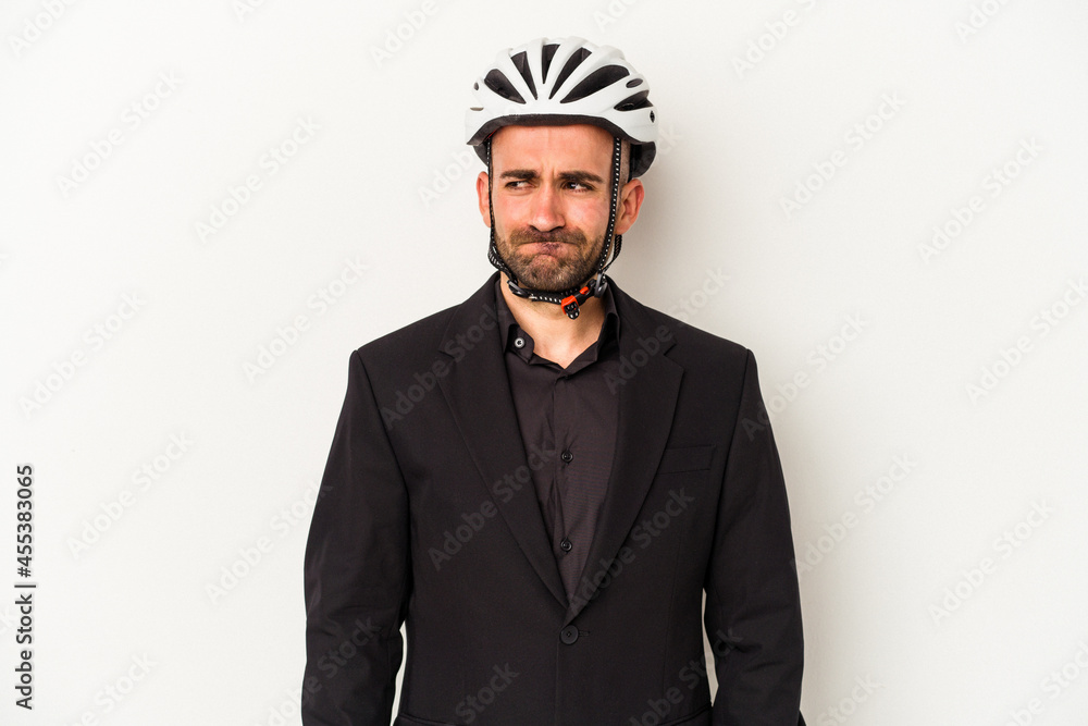 Young business bald man wearing a bike helmet isolated on white background confused, feels doubtful and unsure. Young business bald man wearing a bike helmet isolated on white background confused, feels doubtful and unsure.