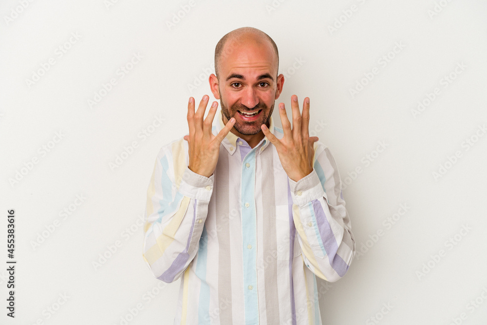 Young bald man isolated on white background showing number ten with hands.