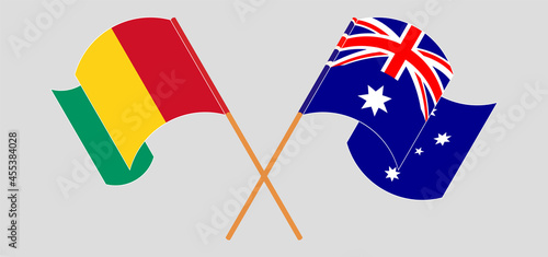Crossed and waving flags of Guinea and Australia