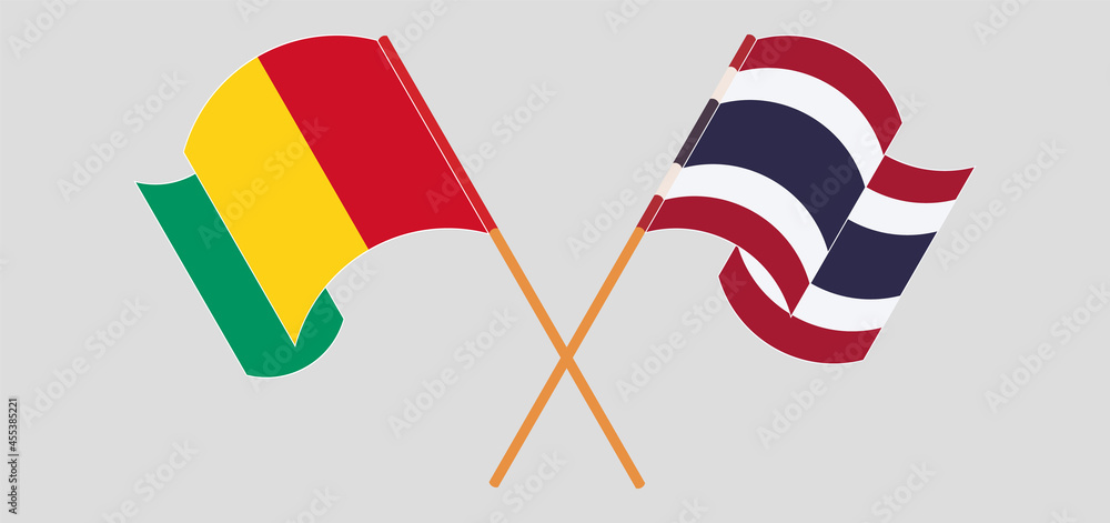 Crossed and waving flags of Guinea and Thailand Crossed and waving flags of Guinea and Thailand