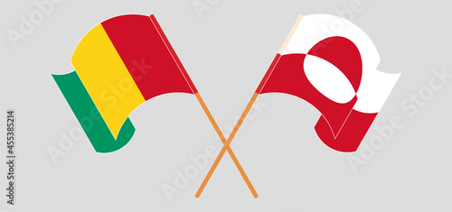 Crossed and waving flags of Guinea and Greenland
