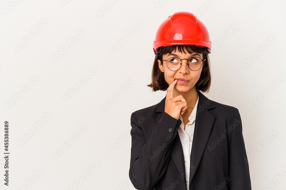 Young architect woman with red helmet isolated on white background looking sideways with doubtful and skeptical expression. Young architect woman with red helmet isolated on white background looking sideways with doubtful and skeptical expression.