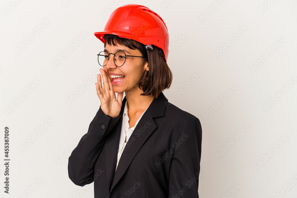 Young architect woman with red helmet isolated on white background shouting and holding palm near opened mouth. Young architect woman with red helmet isolated on white background shouting and holding palm near opened mouth.