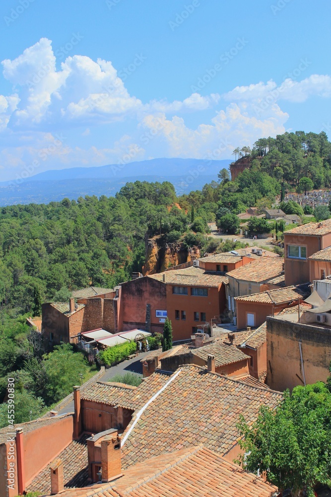 Roussillon in the Luberon area of French Provence, one of the most beautiful villages in France and in Europe, a popular town among tourists. Landscape and cityscape with green scenery.