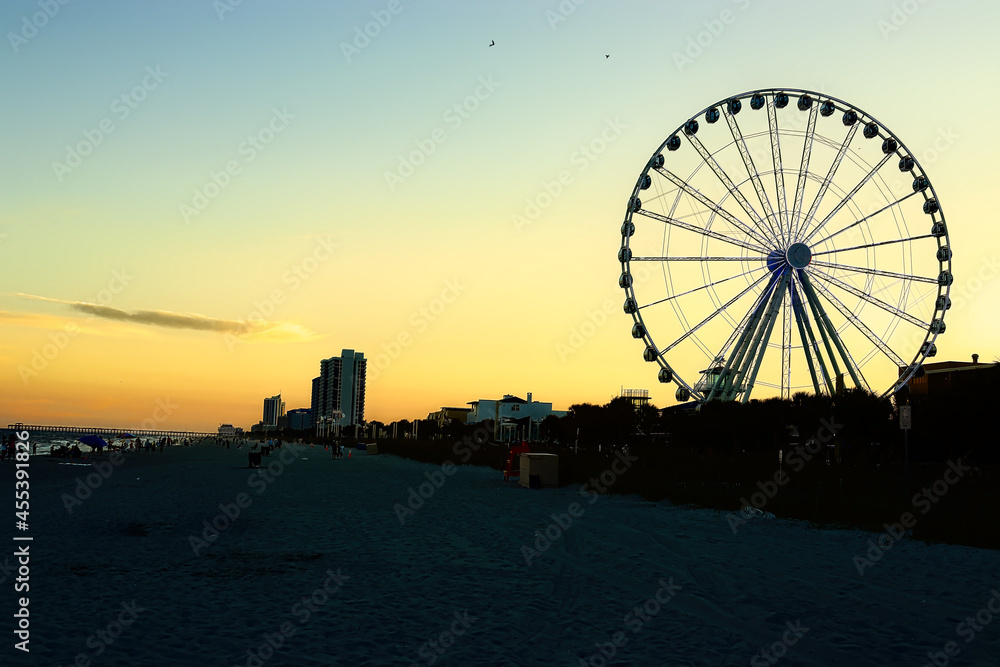 Ferris wheel on sunset background. Sunset ferris wheel silhouette. Ferris wheel silhouette at sunset. Sunset ferris wheel

