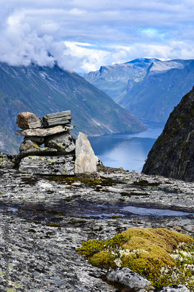 Stone mount in front of scandinavian fiord. Amazing aerial views of a typical norwegian Fjord from a mountain.