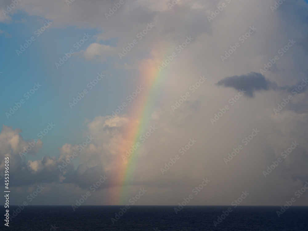 Open ocean storm clearing and rainbow background