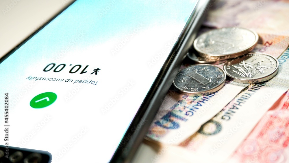 Chinese Yuan Money banknotes and top up smartphone on a white ...