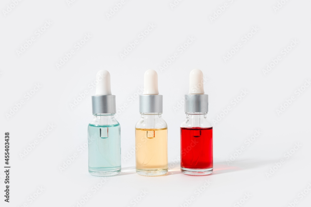 Dropper glass bottles with pipette. Transparent hyaluronic natural beauty mineral product and eco serum skin care concept. Top horizontal view copyspace. Summer juicy colors Dropper glass bottles with pipette. Transparent hyaluronic natural beauty mineral product and eco serum skin care concept. Top horizontal view copyspace. Summer juicy colors