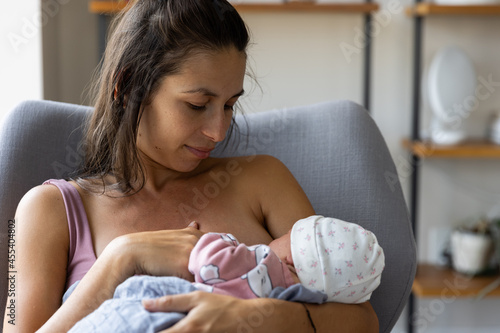 Mother breastfeeds newborn baby - wide view