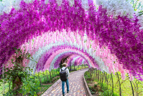 Valokuva A gate of brilliant wisteria flowers surrounds the entrance to the ecological ga