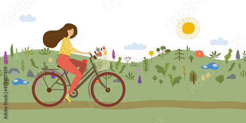 Girl riding bicycle. Park. meadow and hills on background