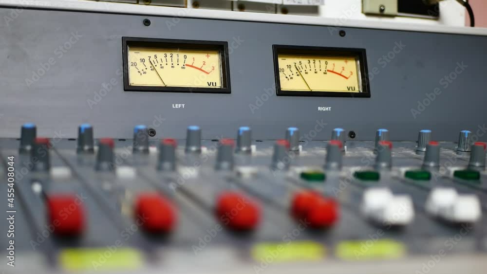 Record sound studio room. Audio equalizer moving bars. Music control levels. Sound control mixer panel. Button front of powered mixer. Sound mixer console, professional audio equipment Record sound studio room. Audio equalizer moving bars. Music control levels. Sound control mixer panel. Button front of powered mixer. Sound mixer console, professional audio equipment