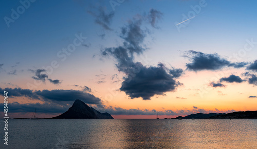 Stunning view of the silhouette of Tavolara Island during a romantic sunrise. Porto Taverna, Sardinia, Italy.