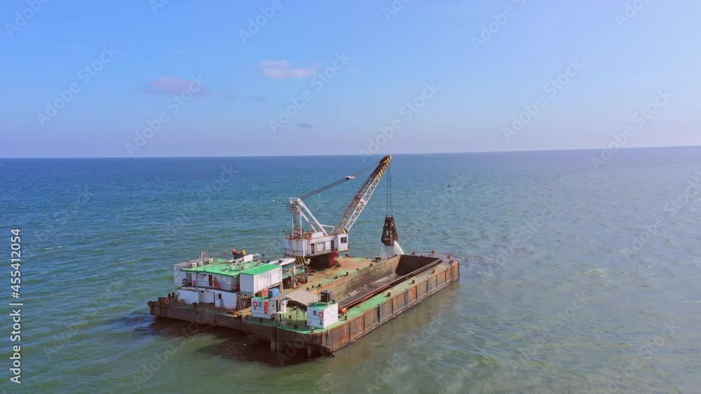 Dredger Equipment Lift Clamshell Bucket With Sand Into Hopper Barge. - aerial Dredger Equipment Lift Clamshell Bucket With Sand Into Hopper Barge. - aerial