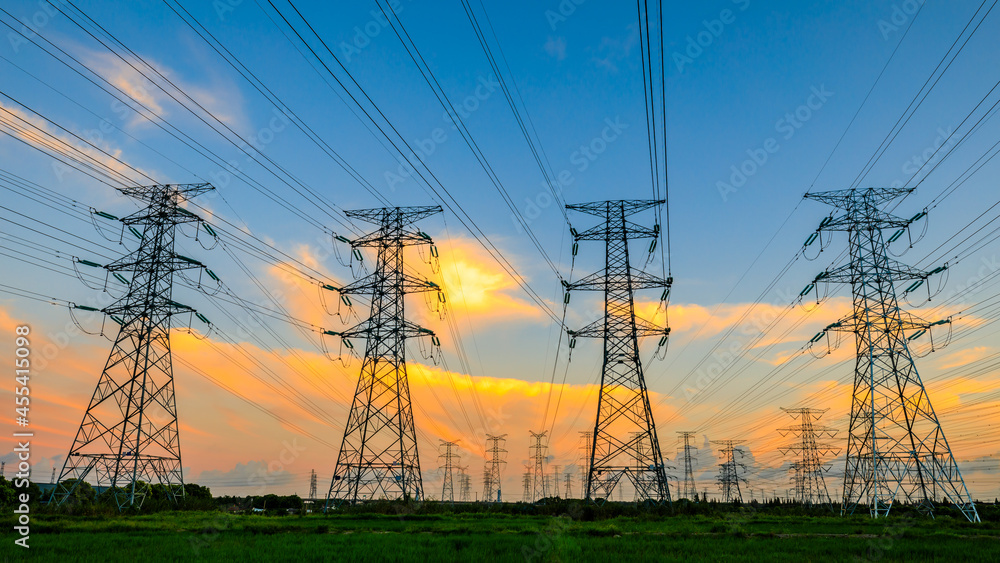 High voltage power tower industrial landscape at sunrise,urban power transmission lines.