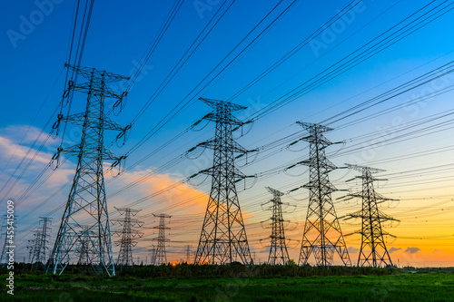 High voltage power tower industrial landscape at sunrise,urban power transmission lines. photo
