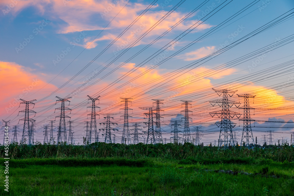 High voltage power tower industrial landscape at sunrise,urban power transmission lines.