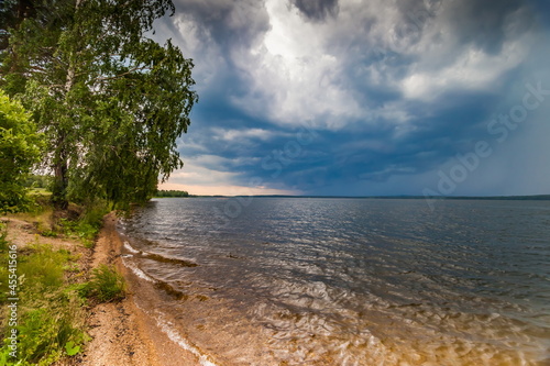Fototapeta Naklejka Na Ścianę i Meble -  The sky with thunderclouds on the pond in summer