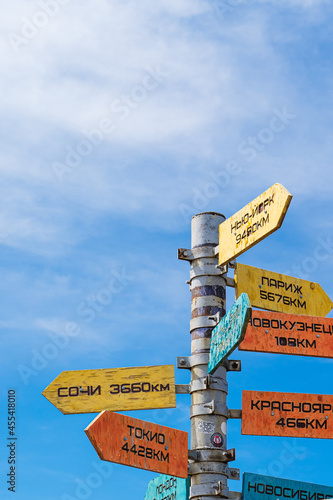 Pointers of distances to different cities and tourists on the top of the Green Sheregesh Mountain.