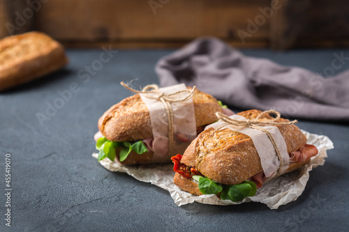 Fresh rye bread sandwich with ham, lettuce and tomato