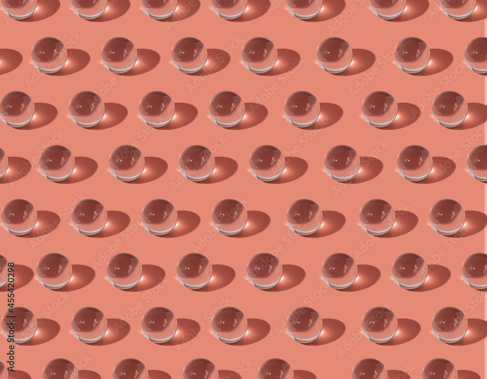 pattern of glass transparent balls on a pink background pattern of glass transparent balls on a pink background