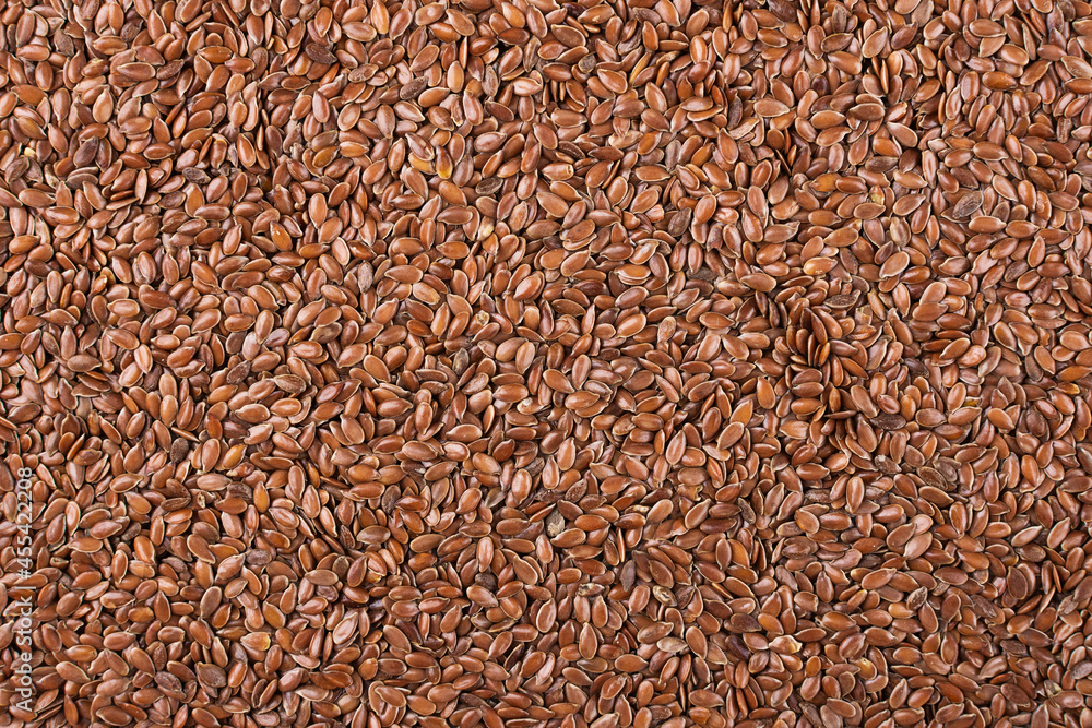 Flax seeds background top view. Flax linen seeds texture. Food background. Flax seeds background top view. Flax linen seeds texture. Food background.
