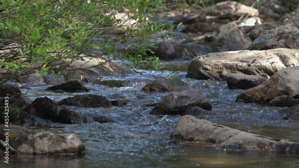 Close-up of a river flowing over rocks in a mountain stream in the Ural Mountains. Close-up of a river flowing over rocks in a mountain stream in the Ural Mountains.