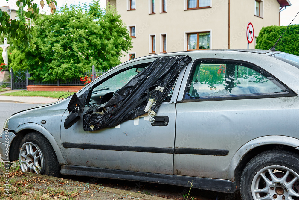 Damaged car parked on the city road Damaged car parked on the city road