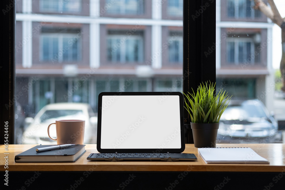 Cropped shot of digital tablet with blank white screen and keyboard, on work desk, copy space Cropped shot of digital tablet with blank white screen and keyboard, on work desk, copy space