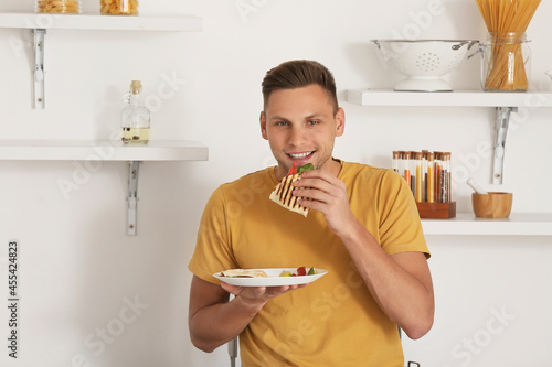 Handsome young man eating t...