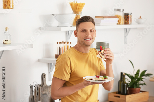 Handsome young man eating t...