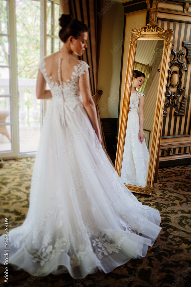 Fototapeta premium the bride at the mirror. selective focus. trying on a wedding dress