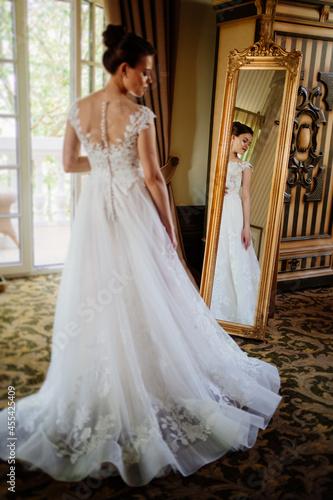the bride at the mirror. selective focus. trying on a wedding dress 