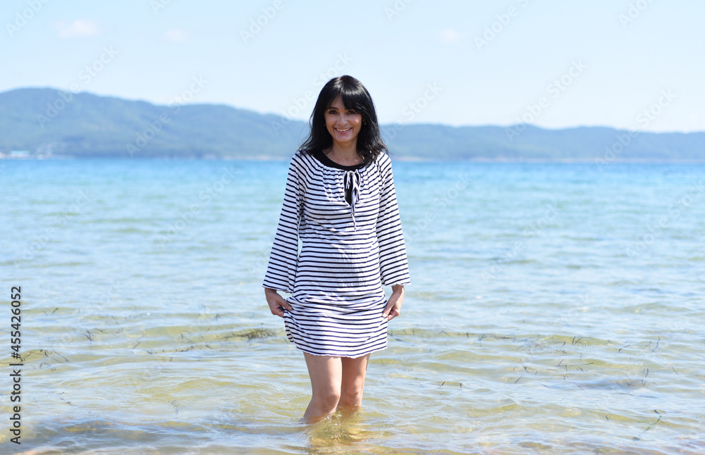 45 years old Russian woman laughing and standing in Japanese sea 45 years old Russian woman laughing and standing in Japanese sea