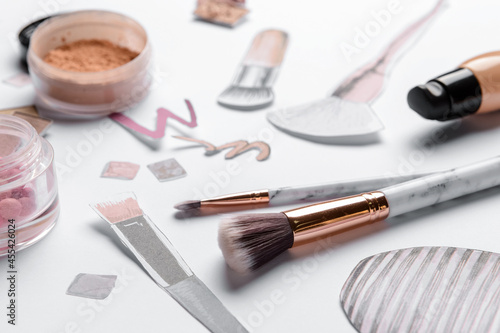 Makeup brushes with drawings on white background, closeup
