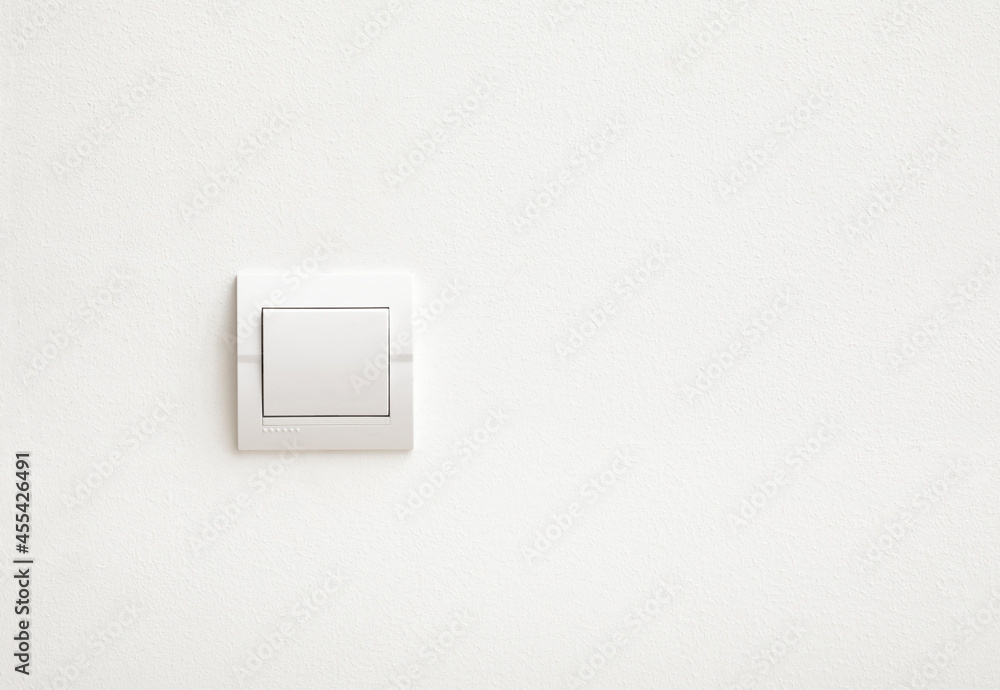 Modern light switch on white wall Modern light switch on white wall
