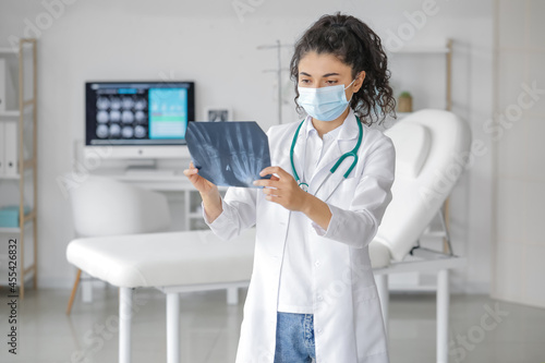 Female doctor studying x-ra...