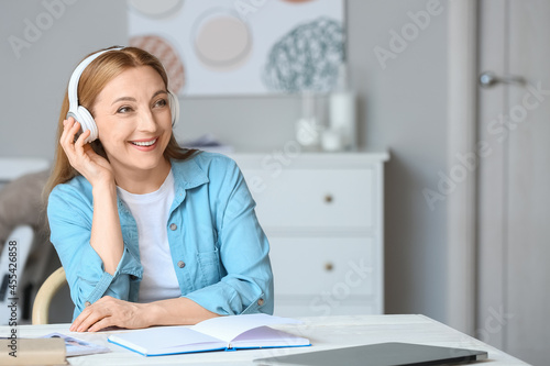 Mature woman listening to a...
