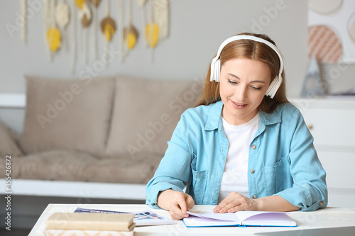 Mature woman with headphone...