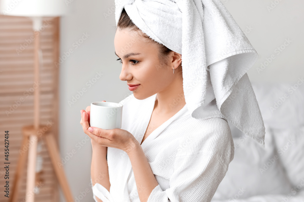 Young woman drinking coffee in bedroom Young woman drinking coffee in bedroom
