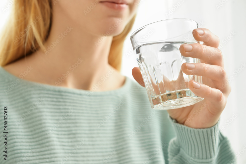 Woman drinking fresh water, closeup