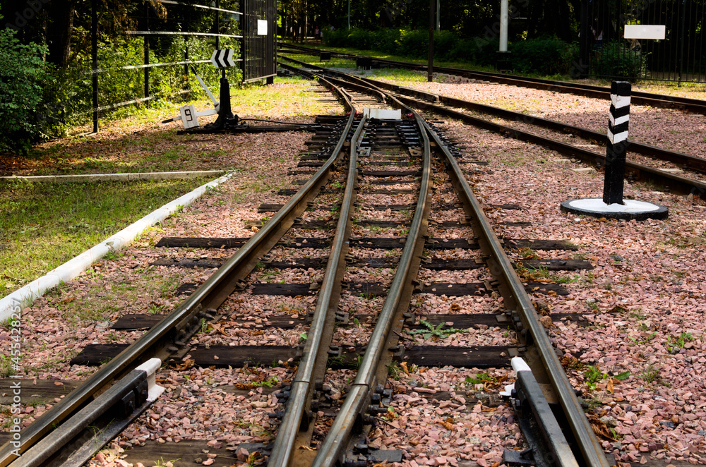 Narrow gauge railway tracks with switches and interchanges at Kyiv Children's Railway in Syretsky Park. Geometrical structures, thresholds, gravel and screws
