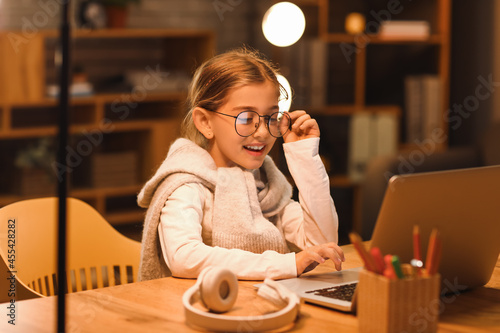 Little girl studying online...
