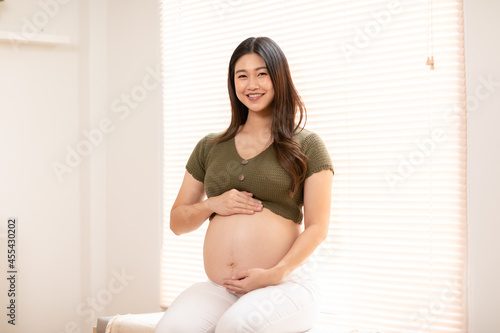 Happy Pregnant Woman sitting on couch holding and stroking her big belly at cozy home,Pregnancy of young woman enjoying with future life relax at home,Motherhood and Pregnant Concept,Soft focus Free Download Happy Pregnant Woman sitting on couch holding and stroking her big belly at cozy home,Pregnancy of young woman enjoying with future life relax at home,Motherhood and Pregnant Concept,Soft focus - GFXLoad